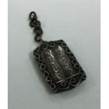 A Judaica silver charm mounted with 'The Ten Comma