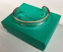 TIFFANY & CO: A heavy silver torque bangle contain