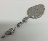 A Continental silver preserve spoon decorated with