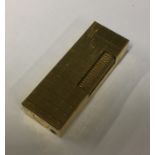 A Dunhill gold plated lighter. Est. £20 - £30.