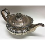 A good Georgian silver teapot attractively cast wi