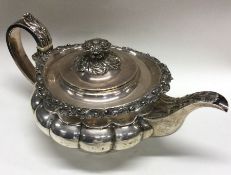 A good Georgian silver teapot attractively cast wi