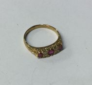 A ruby and diamond seven stone ring in carved 9 ca
