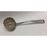 A pierced silver sauce ladle decorated with fruit.
