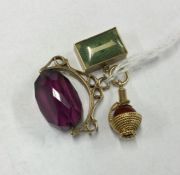 A group of three gold mounted charms. Approx. 18 g