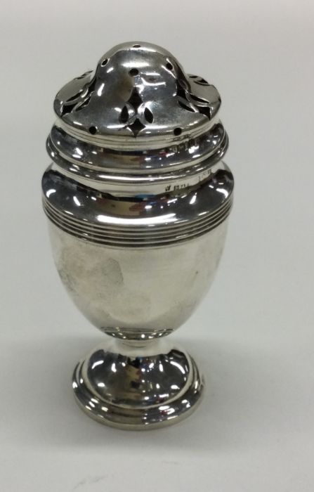 A small baluster shaped silver caster of ovoid sha