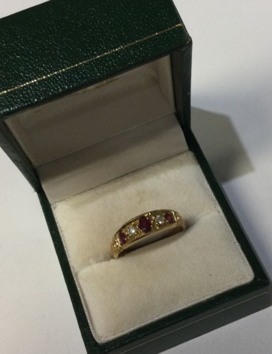 An 9 carat ruby and diamond five stone ring. Appro