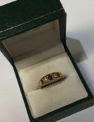 An 9 carat ruby and diamond five stone ring. Appro