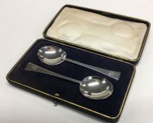 A pair of tapering silver preserve spoons containe