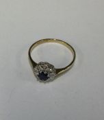 A 9 carat sapphire and diamond circular cluster ri