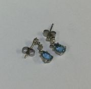 A pair of diamond mounted drop earrings with pear