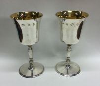 A heavy pair of tapering silver goblets with gilde