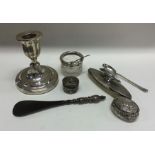 A box containing a silver nail buffer, candlestick