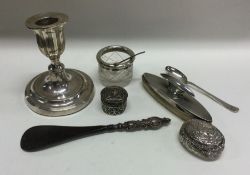 A box containing a silver nail buffer, candlestick