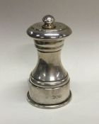 An Edwardian silver pepper grinder of typical form