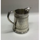 An Edwardian tapering silver cream jug with beaded