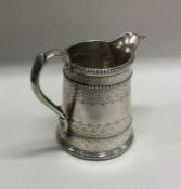 An Edwardian tapering silver cream jug with beaded