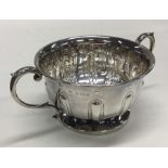 A heavy two handled silver bowl with fluted body.