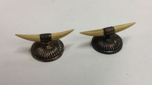 A heavy pair of silver half fluted knife rests. Sh