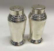 A pair of Art Deco silver peppers of typical form