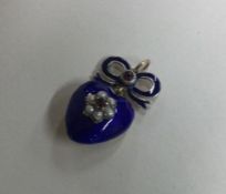 A good enamelled heart shaped pendant with bow loo