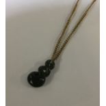 A small 9 carat necklace with hardstone pendant. A