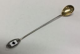 A large silver and silver gilt bridge spoon with e