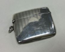 A heavy silver vesta case with engine turned decor