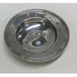 A small circular silver armada dish of typical for