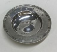 A small circular silver armada dish of typical for