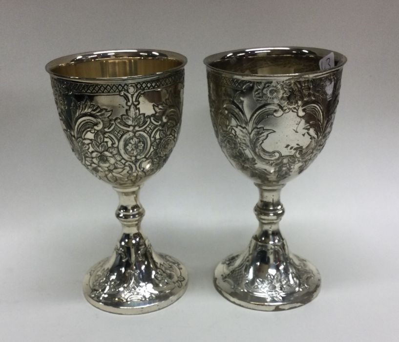 A good pair of chased silver plated goblets. Est.