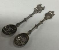 A pair of chased silver spoons decorated with figu