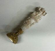 A finely carved Continental gold and ivory taperin