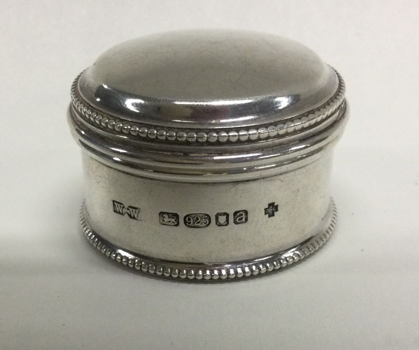 A heavy silver pill box with dome top to lift-off