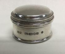 A heavy silver pill box with dome top to lift-off
