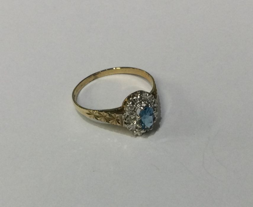 A diamond and topaz cluster ring in 9 carat claw m
