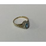 A diamond and topaz cluster ring in 9 carat claw m