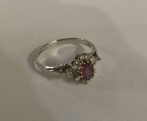 A 9 carat pink stone cluster ring in gold claw mou