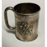 A small silver christening cup decorated with flow