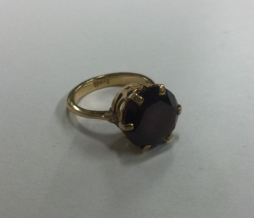 An 18 carat gold amethyst single stone ring in cla