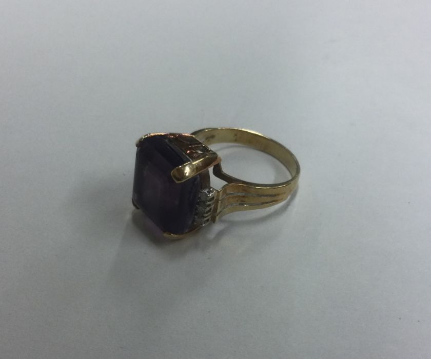 A stylish amethyst and diamond single stone ring o