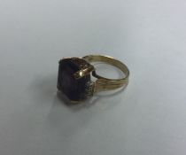 A stylish amethyst and diamond single stone ring o