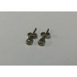 A pair of good diamond single stone ear studs in r