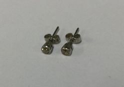 A pair of good diamond single stone ear studs in r