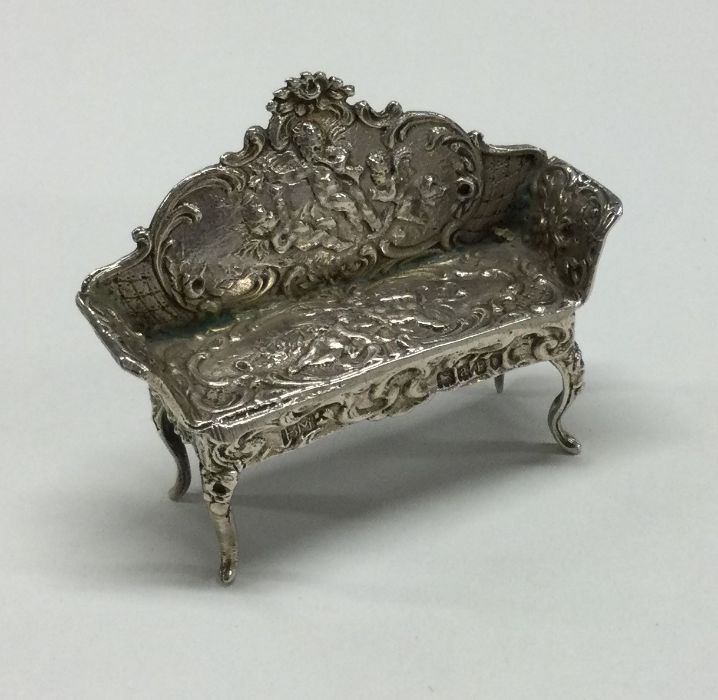 A small cherub mounted saloon chair of shaped form