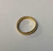 A 22 carat gold plain wedding band. Approx. 4 gram