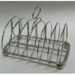 A large seven bar Georgian silver toast rack on ba