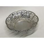 A circular pierced silver sweet dish decorated wit