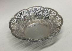 A circular pierced silver sweet dish decorated wit