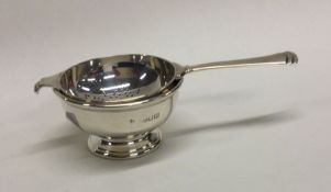 A silver tea strainer on pedestal foot. London. Ap